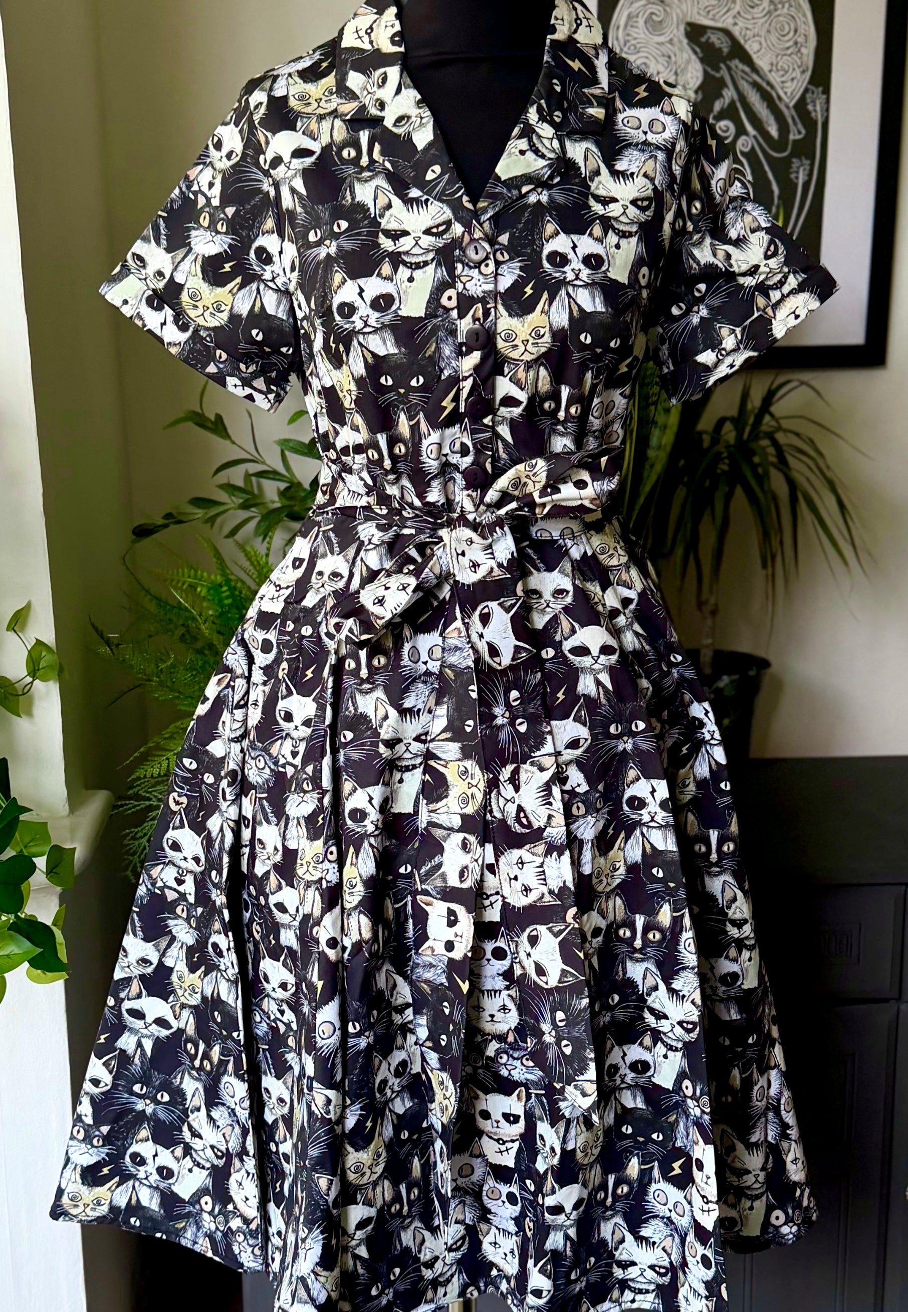 Alley cats patterned dress on a mannequin against a neutral background