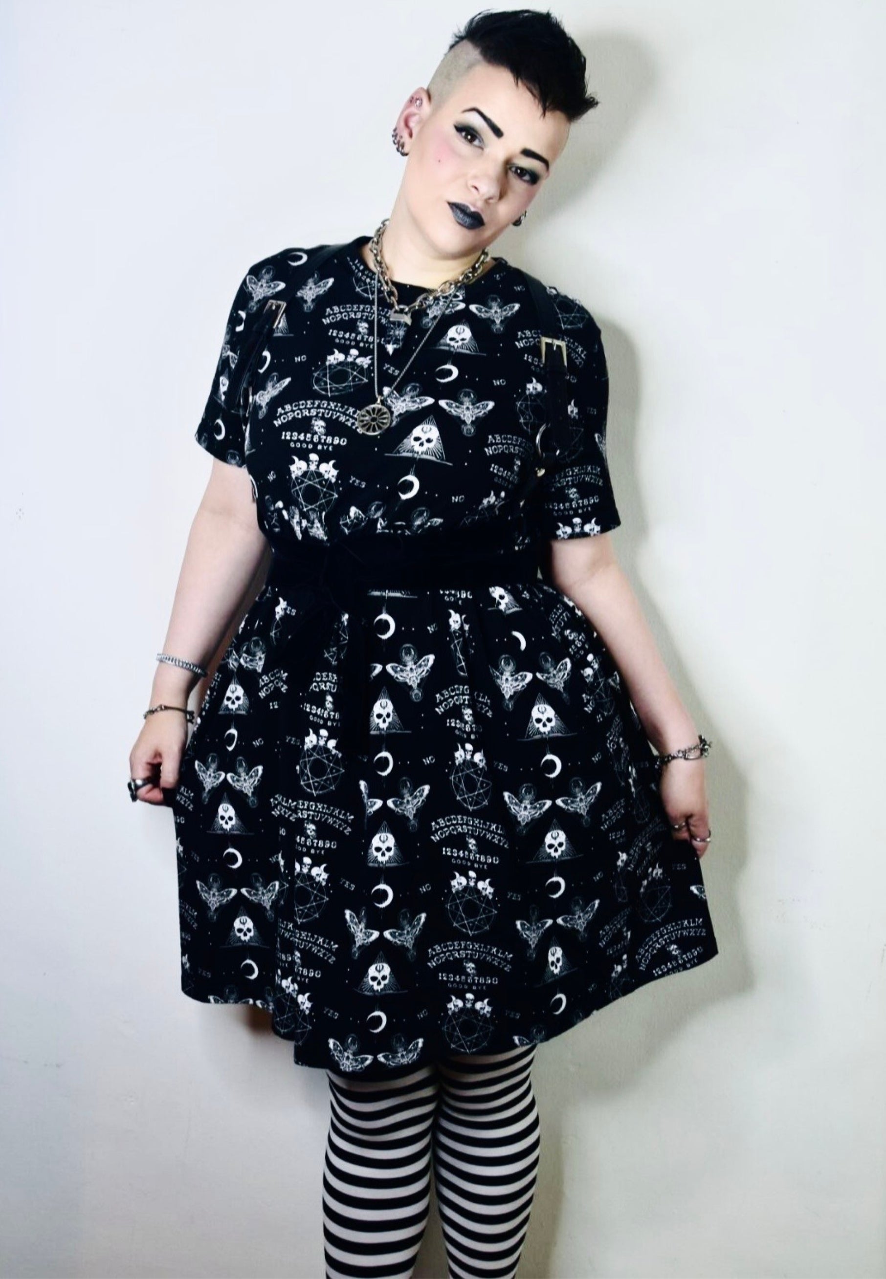 Woman wearing a black Ouija smock dress.