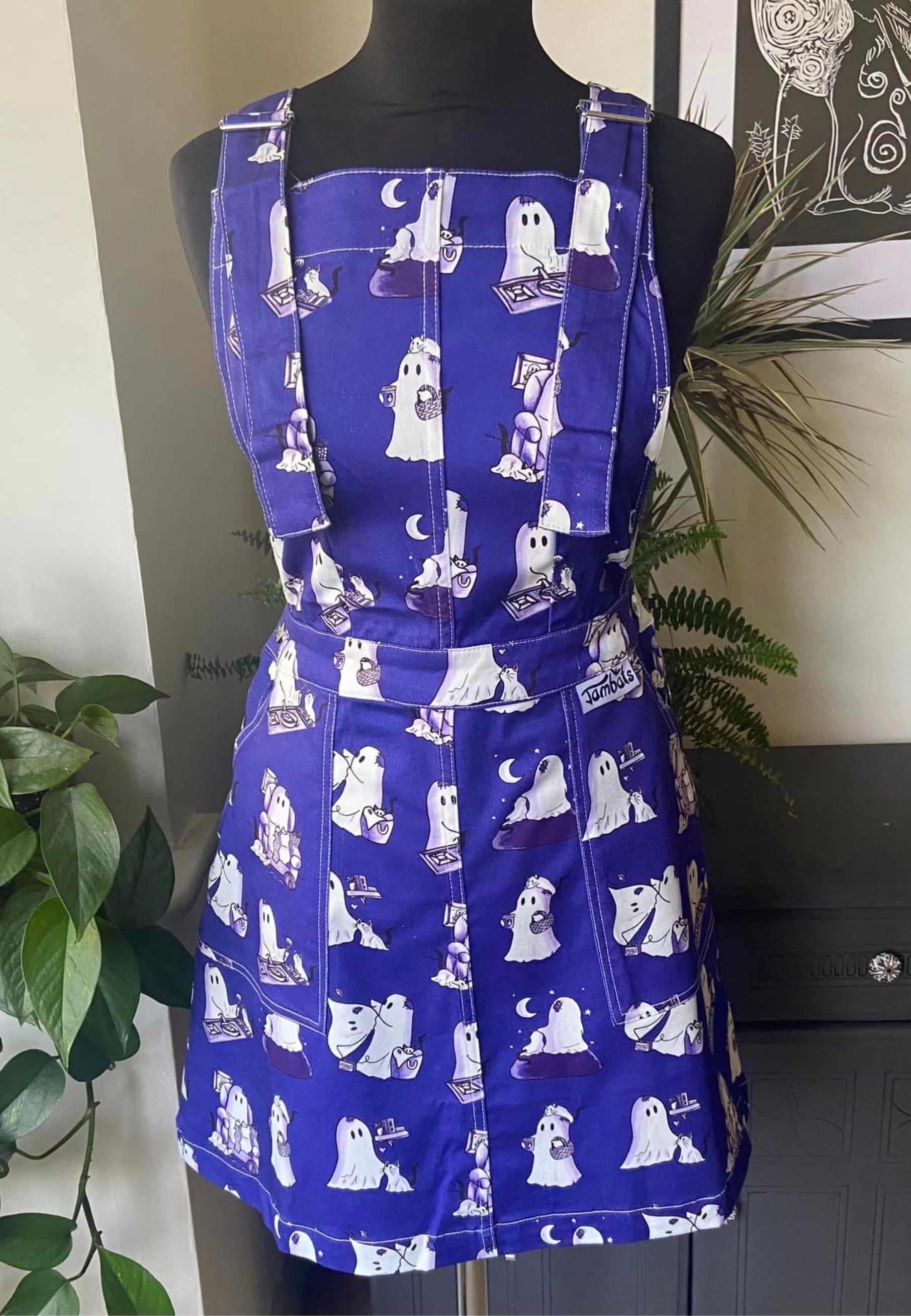 A beautiful blue pinafore with cute images of ghosts and ghost cats doing everyday things. Jambats January Sale. 