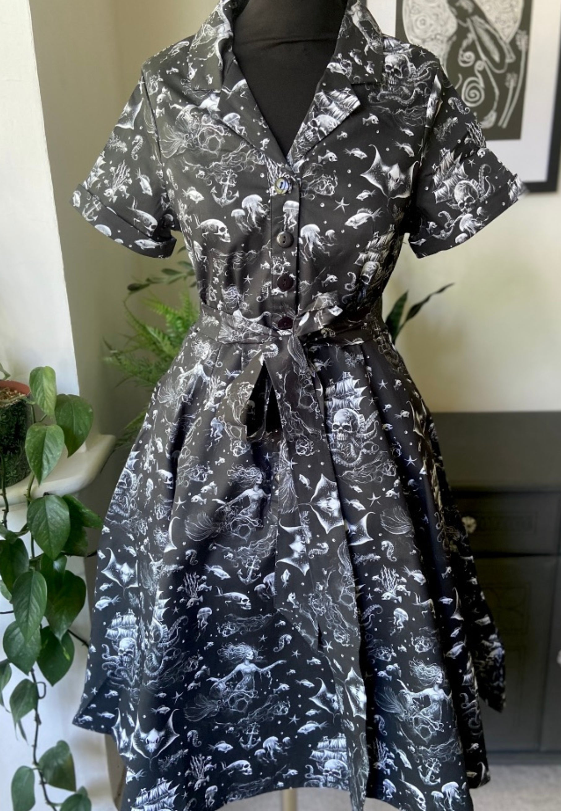 Beautiful black shirt dress with gothic sea print on a mannequin against a neutral background