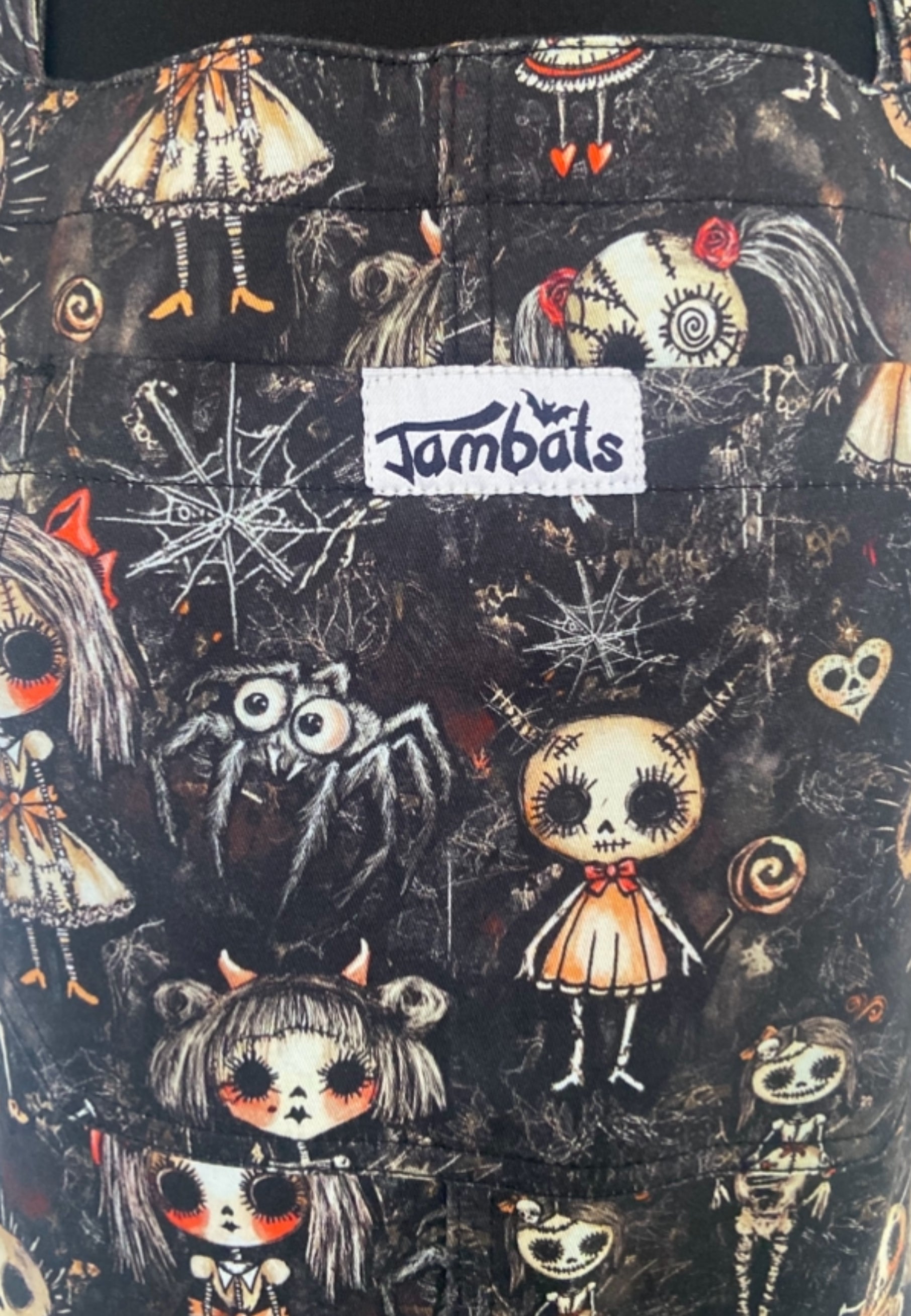 Close up photo of Haunted Dolls print. Creepy dolls on a background of dusty cobwebs. 