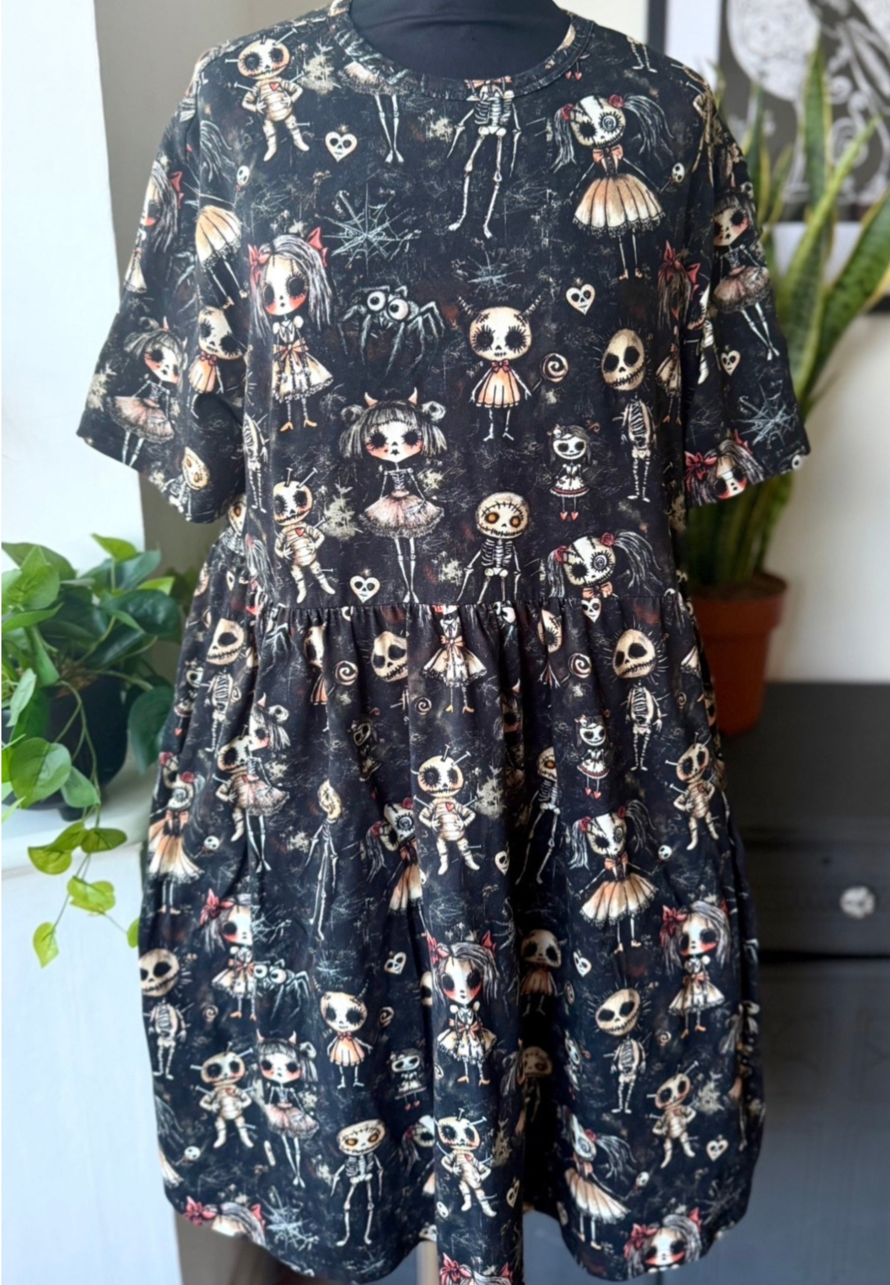 Dress with haunted dolls creepy print on a mannequin in a neutral background  