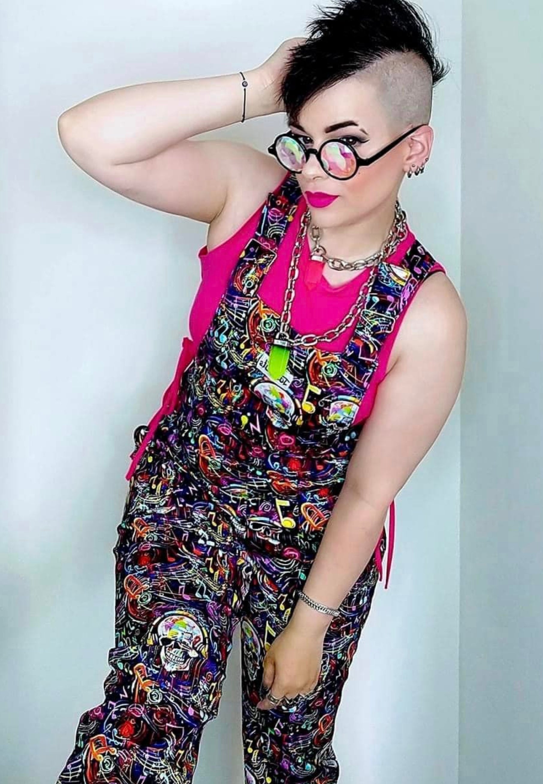 Woman wearing Graffiti Music Skulls Dungarees and quirky glasses. 80s 90s vibe. 