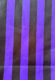 A close-up of a striped fabric or material with alternating wide purple and black vertical stripes.