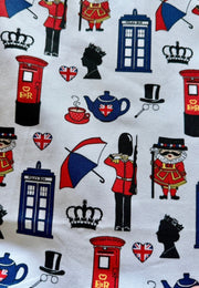 Fabric print of British-themed icons including red telephone boxes, teapots, and guards on a white background.
