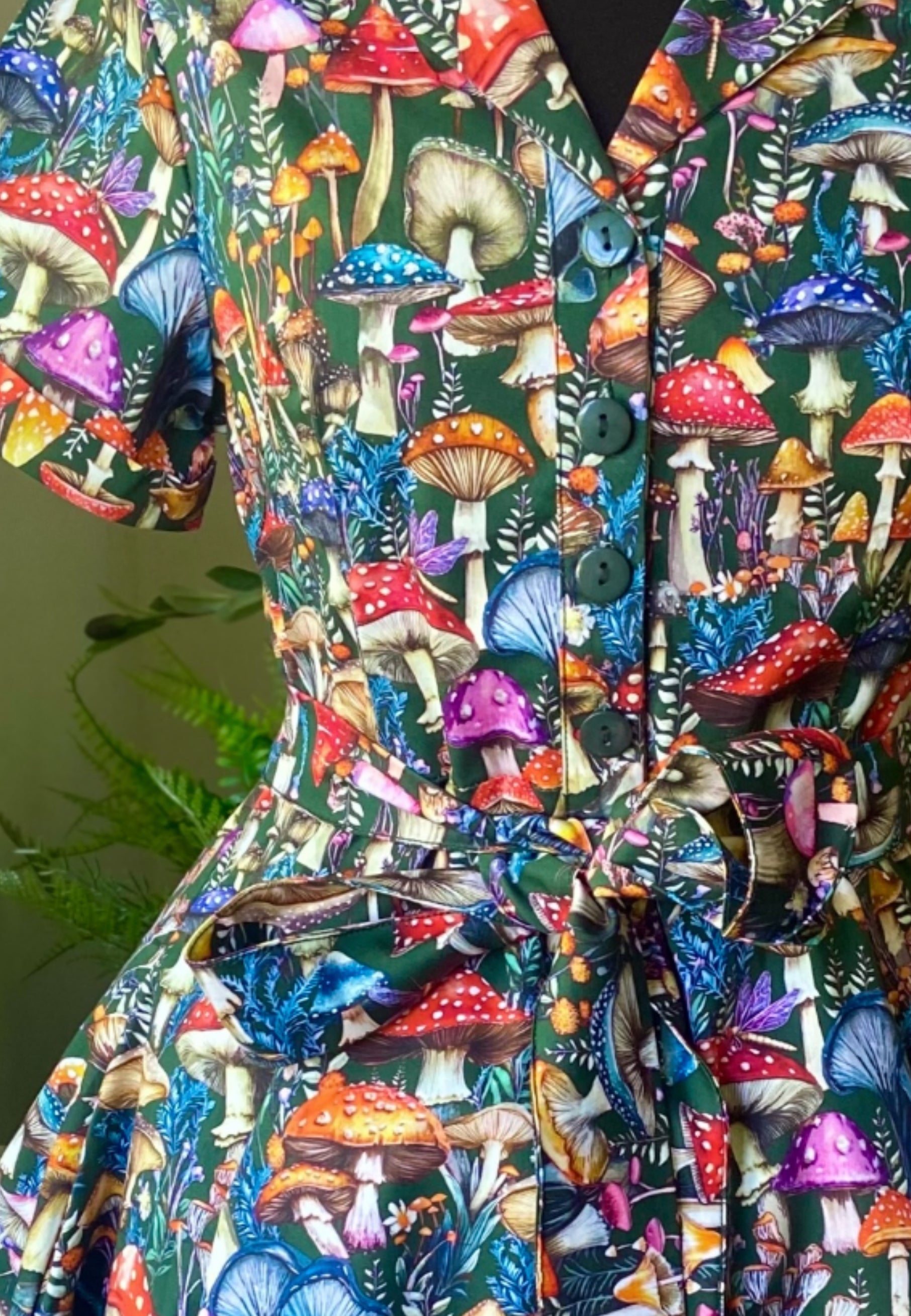 Close up of the print of Jambats Wild Shroom Dress on a mannequin. Print is a beautiful chaotic collection of vibrant wild mushrooms. Cottagecore style. 