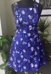 Beautiful blue pinafore dress with a celestial zodiac print. Displayed on a mannequin. 